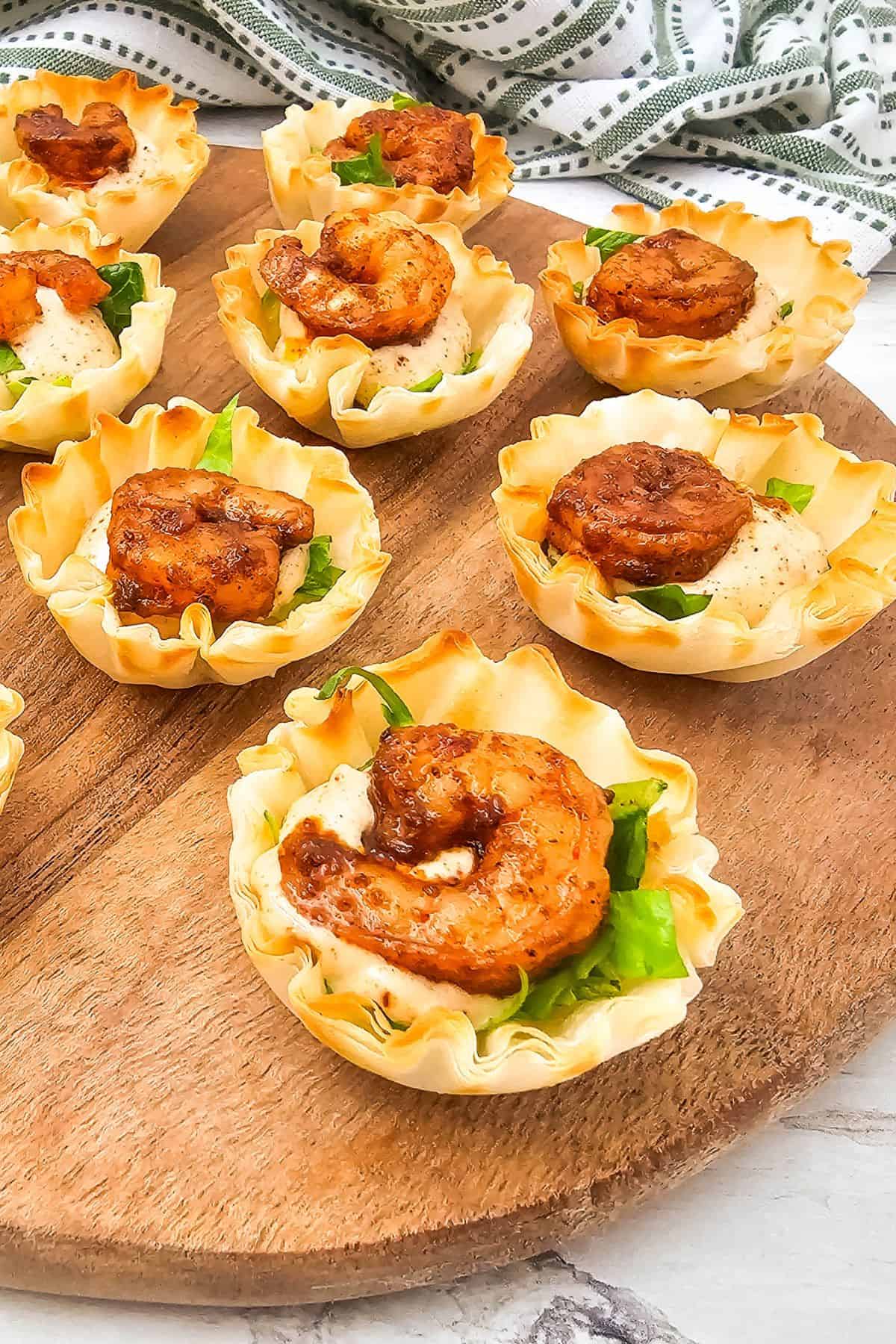 Delicious bite-sized chicken tarts in flaky pastry shells topped with tender chicken and green onions. Perfect appetizer for any gathering.
