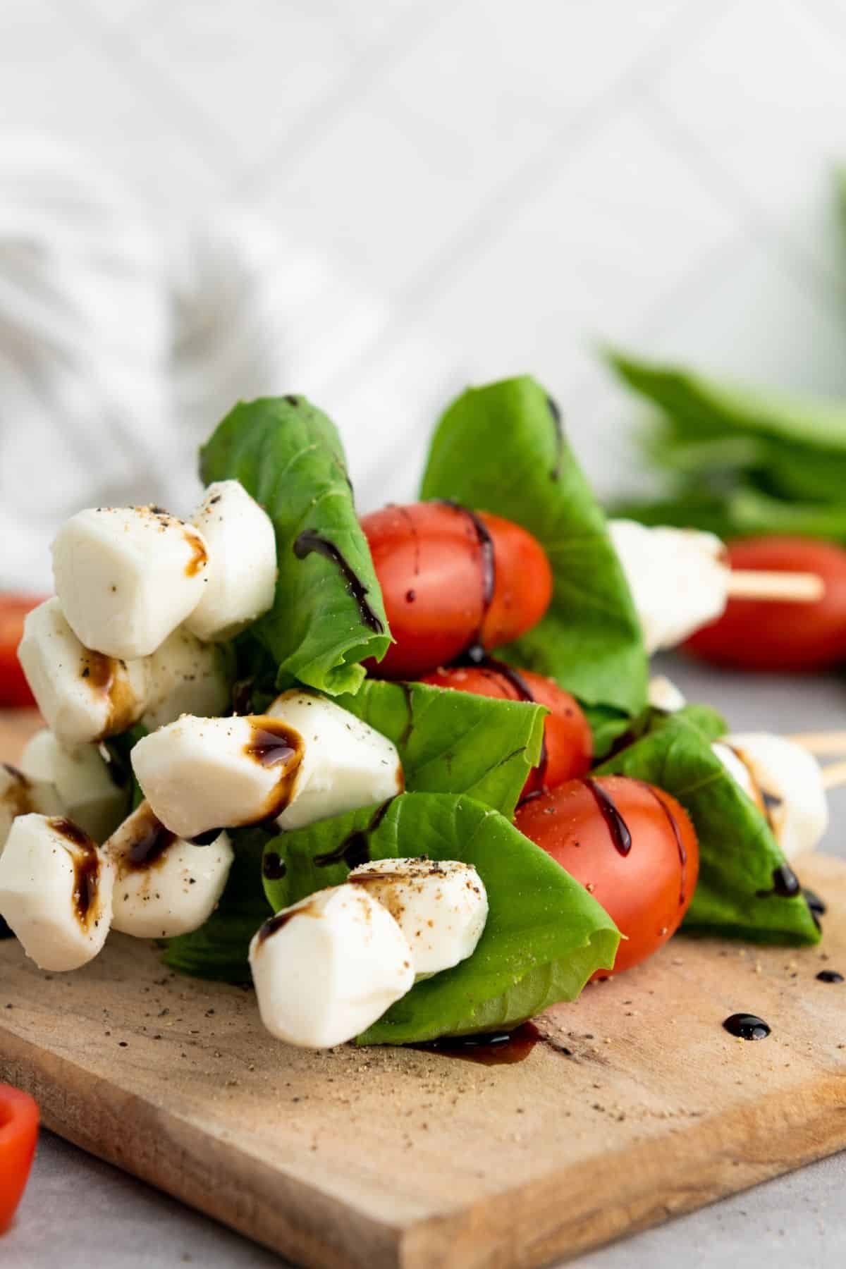 Bright, easy-to-make appetizer with cherry tomatoes, basil, and mozzarella drizzled with balsamic glaze. Perfect for Easter parties.